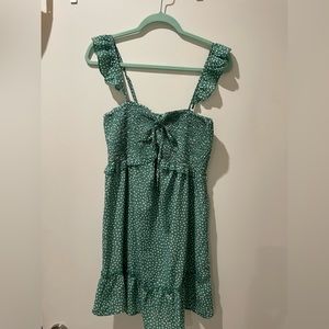 Green sundress with adjustable straps and bow in the front.